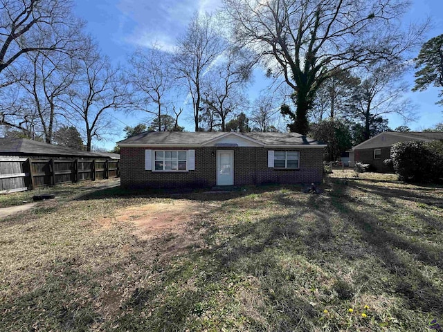 view of front of house with brick siding and fence