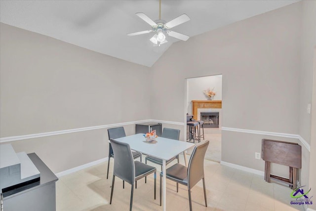 210 Cumberland Woods Ter, Warner Robins, GA 31088 - dining room with lofted ceiling, ceiling fan, a tiled fireplace, and baseboards