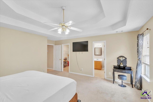 210 Cumberland Woods Ter, Warner Robins, GA 31088 - bedroom with a raised ceiling, light carpet, connected bathroom, and baseboards