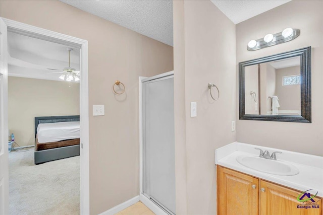 210 Cumberland Woods Ter, Warner Robins, GA 31088 - full bathroom with a textured ceiling, vanity, baseboards, a shower stall, and ensuite bath