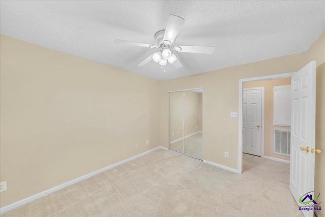 210 Cumberland Woods Ter, Warner Robins, GA 31088 - unfurnished bedroom featuring a textured ceiling, a closet, visible vents, and light colored carpet