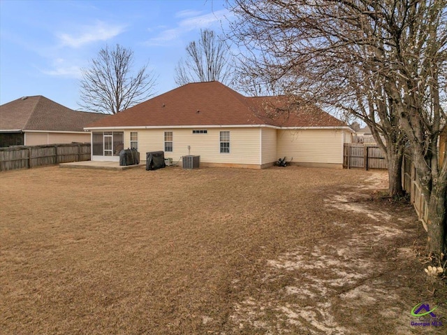 210 Cumberland Woods Ter, Warner Robins, GA 31088 - back of property featuring central AC unit, a fenced backyard, a sunroom, a yard, and a patio area