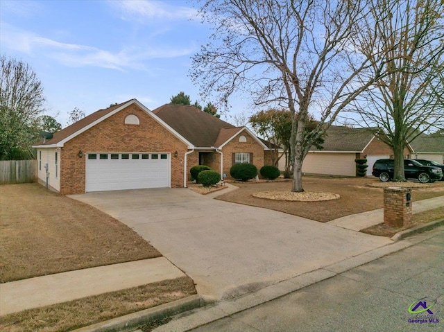 210 Cumberland Woods Ter, Warner Robins, GA 31088 - ranch-style house with an attached garage, fence, concrete driveway, and brick siding