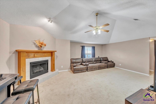 210 Cumberland Woods Ter, Warner Robins, GA 31088 - carpeted living area with lofted ceiling, a tile fireplace, visible vents, and baseboards
