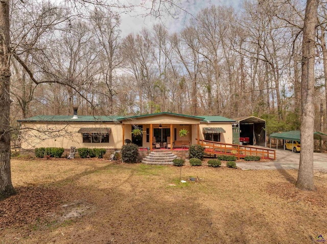 view of front of home featuring covered porch, a front lawn, and stucco siding