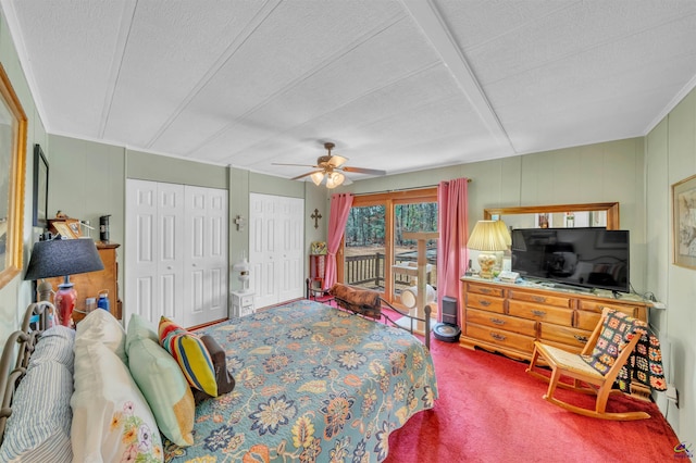 bedroom featuring a textured ceiling, carpet flooring, a ceiling fan, access to exterior, and two closets