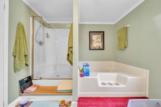 bathroom featuring ornamental molding, a stall shower, and a bath