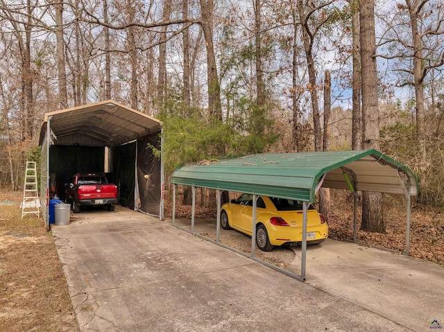 view of vehicle parking with concrete driveway and a detached carport