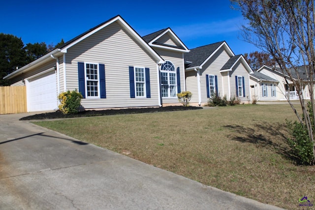 ranch-style house featuring a garage, driveway, and a front lawn