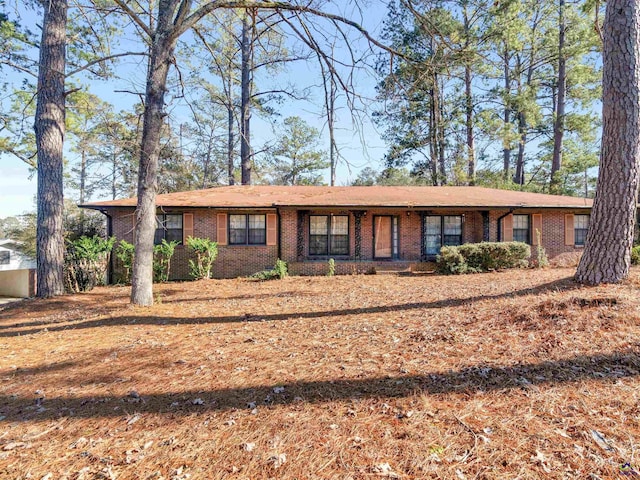 single story home featuring brick siding