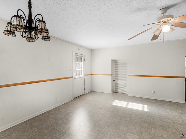 empty room with baseboards, ceiling fan, a textured ceiling, and tile patterned floors