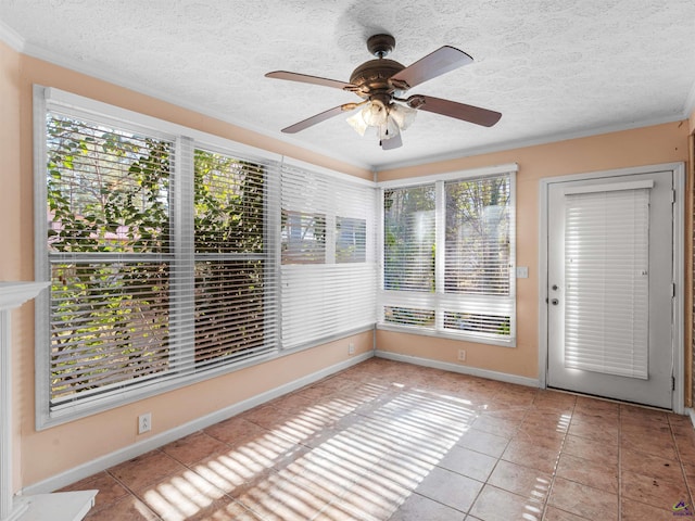 unfurnished sunroom featuring a ceiling fan