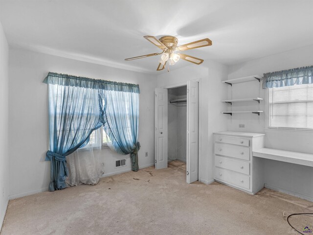 unfurnished bedroom with multiple windows, visible vents, a closet, and light colored carpet