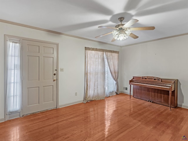 foyer with baseboards, ornamental molding, visible vents, and light wood-style floors