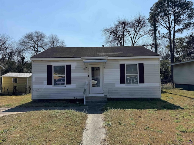 bungalow-style house with entry steps and a front yard