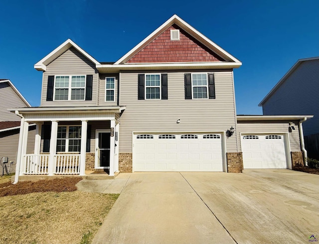 craftsman-style house with covered porch, driveway, and an attached garage