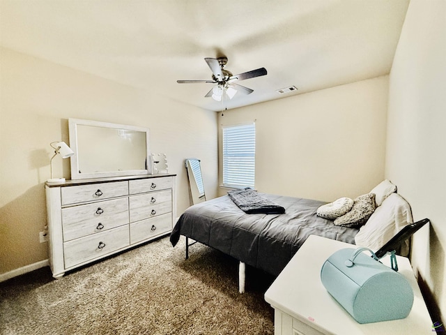 bedroom with baseboards, carpet, visible vents, and a ceiling fan