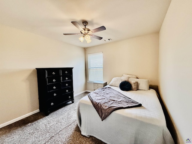 carpeted bedroom with a ceiling fan, visible vents, and baseboards