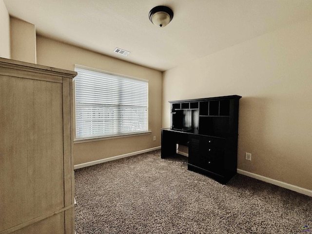 unfurnished bedroom with carpet, visible vents, and baseboards