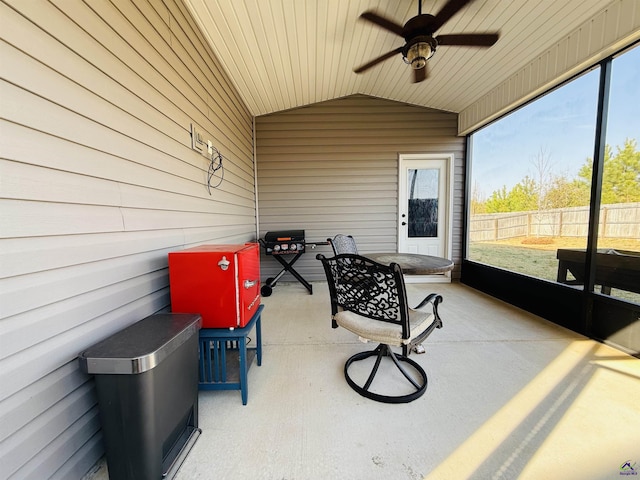 sunroom with lofted ceiling and a ceiling fan