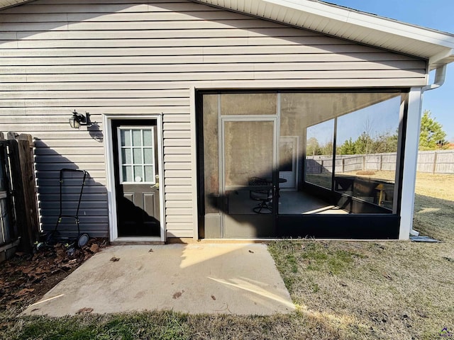 doorway to property featuring fence