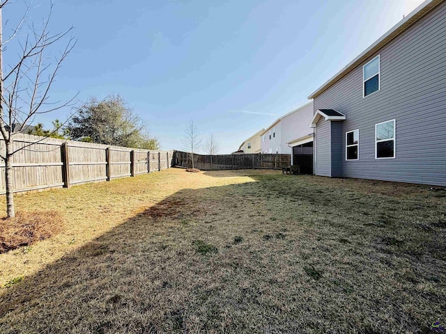 view of yard with a fenced backyard