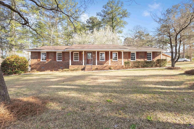 ranch-style home with crawl space, a porch, a front lawn, and brick siding