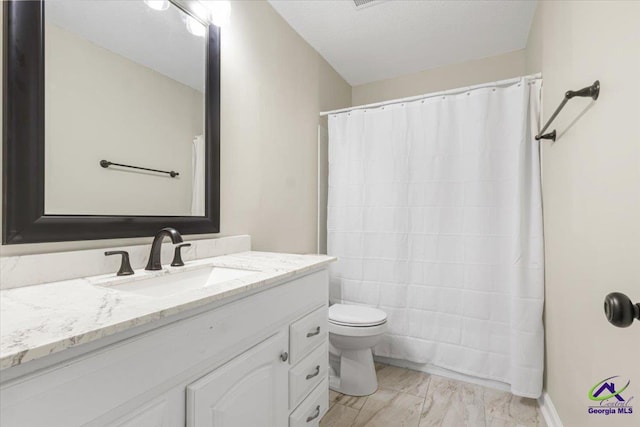 bathroom with toilet, marble finish floor, a shower with shower curtain, and vanity