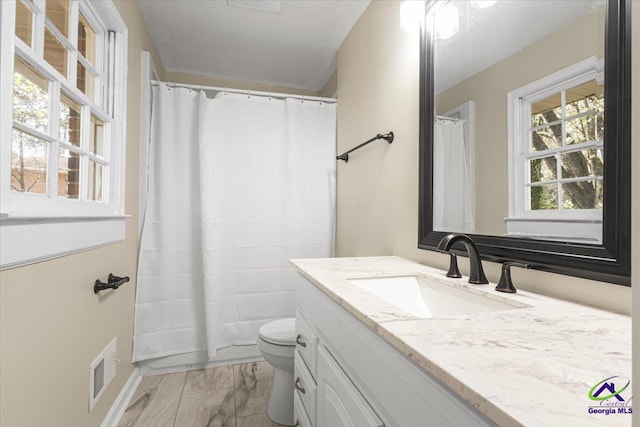 full bathroom featuring visible vents, toilet, a shower with curtain, marble finish floor, and vanity