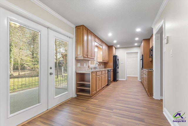 kitchen with french doors, crown molding, open shelves, light wood-style floors, and black appliances