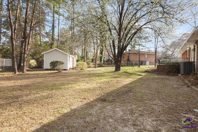 view of yard with fence, an outdoor structure, and central air condition unit