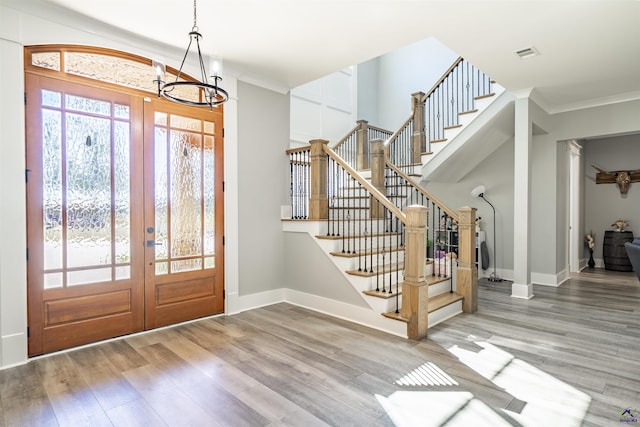 entryway with stairs, french doors, wood finished floors, and baseboards