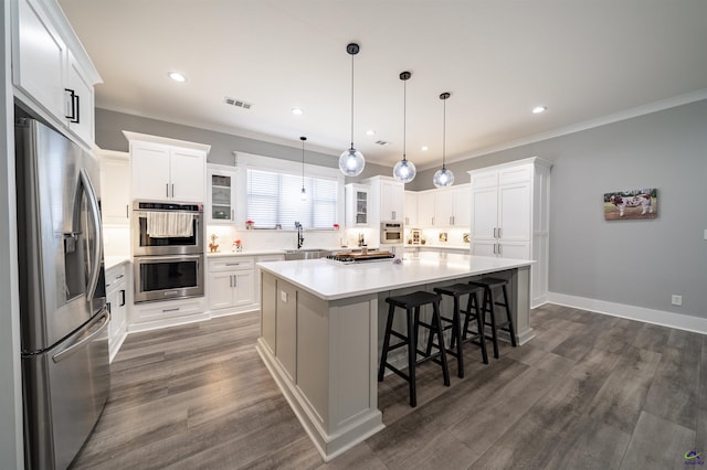 kitchen with white cabinetry, visible vents, stainless steel appliances, and a sink