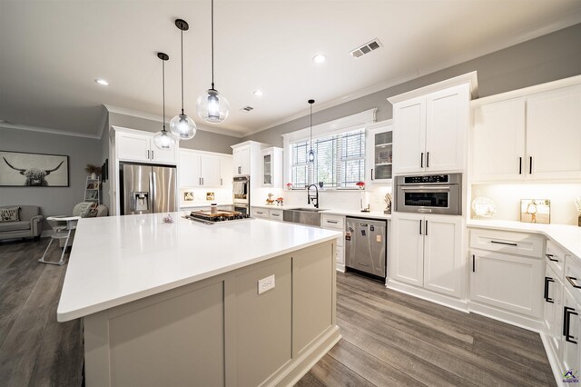 kitchen with visible vents, dark wood-style floors, glass insert cabinets, appliances with stainless steel finishes, and ornamental molding