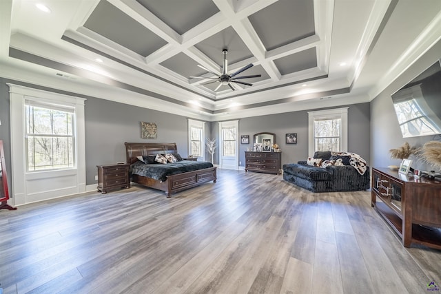 bedroom featuring visible vents, coffered ceiling, ceiling fan, wood finished floors, and crown molding