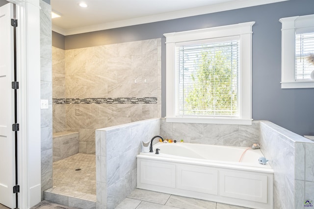 bathroom with tile patterned floors, walk in shower, a garden tub, and a healthy amount of sunlight