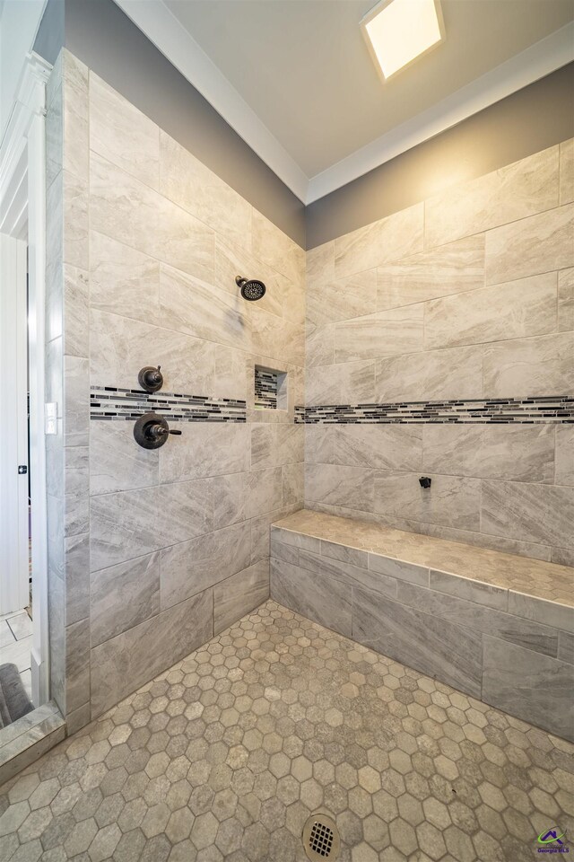 full bath featuring tiled shower