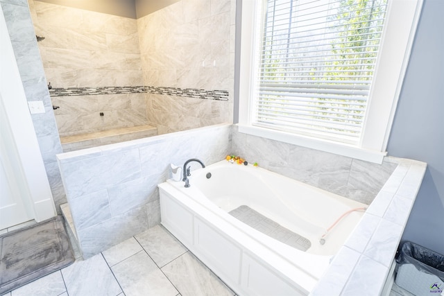 bathroom featuring plenty of natural light, a bath, and tile patterned floors