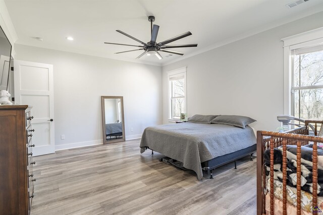 bedroom featuring ornamental molding, recessed lighting, light wood-style flooring, and baseboards