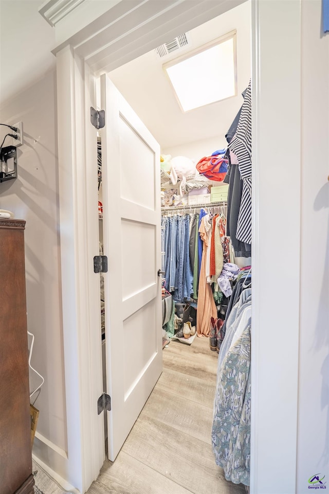 spacious closet with light wood-type flooring and visible vents