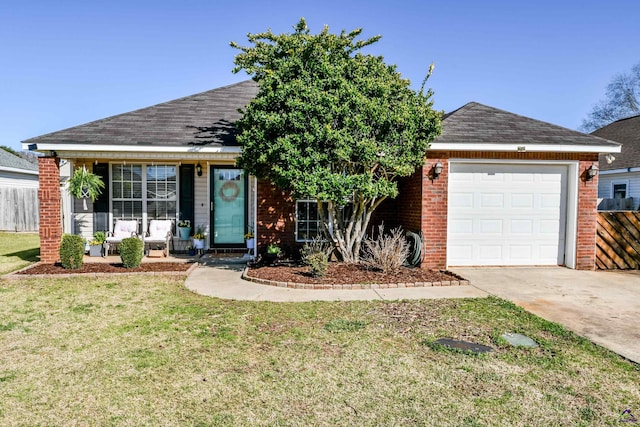 ranch-style home with a front yard, concrete driveway, brick siding, and an attached garage