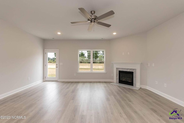 unfurnished living room with light wood-style floors, baseboards, and recessed lighting