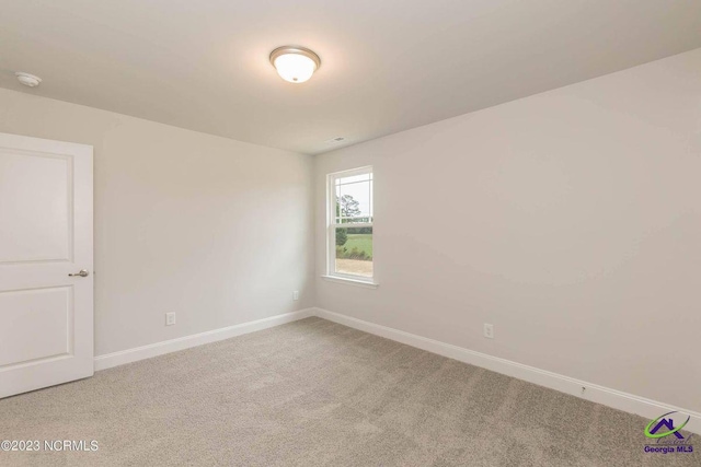 carpeted empty room with baseboards