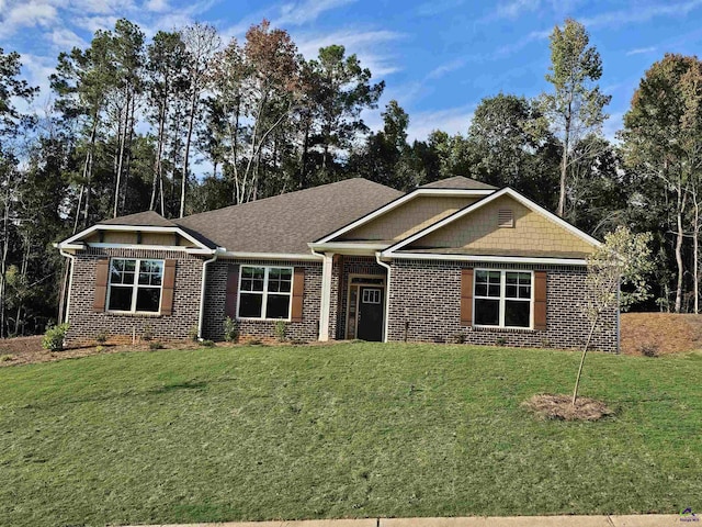 craftsman inspired home with brick siding and a front lawn