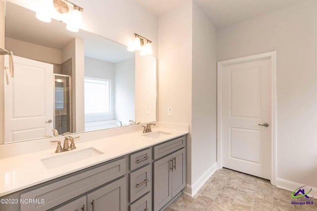 bathroom with double vanity, a stall shower, a sink, and a bath