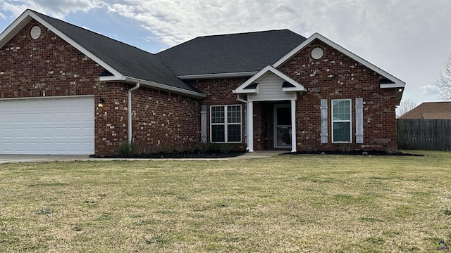 traditional home featuring brick siding, a shingled roof, an attached garage, fence, and a front lawn