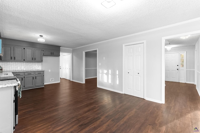 kitchen with crown molding, stainless steel electric range, dark wood finished floors, and decorative backsplash