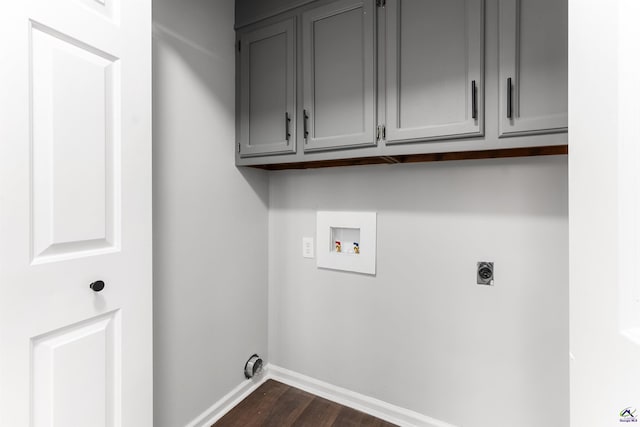 laundry room with hookup for a washing machine, hookup for an electric dryer, dark wood-style flooring, baseboards, and cabinet space