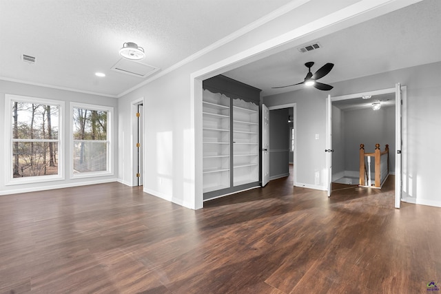 unfurnished living room with wood finished floors, visible vents, and baseboards