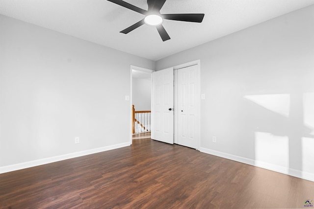 unfurnished bedroom featuring a ceiling fan, a closet, baseboards, and wood finished floors